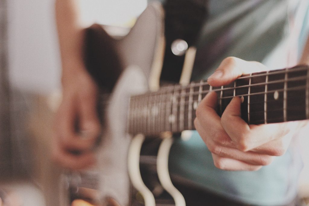 Tutor Playing a Guitar Private Tutoring